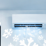 an air conditioning unit installed on a wall with a cold air graphic