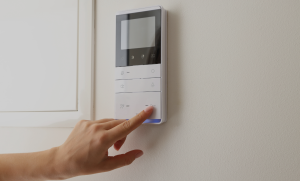 a person using a controller to change the settings on their air conditioning unit