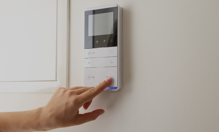 a person using a controller to change the settings on their air conditioning unit