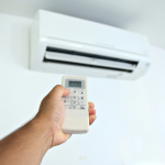 A man using a controller to control his air conditioning