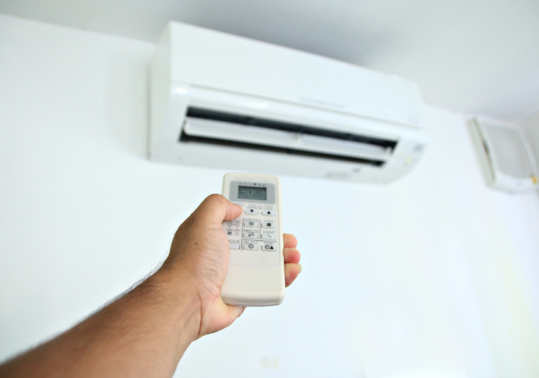 A man using a controller to control his air conditioning
